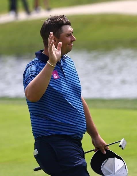 Marcus Armitage of England reacts to a cheer on the 18th hole during Day Three of The Porsche European Open at Green Eagle Golf Course on June 07,...