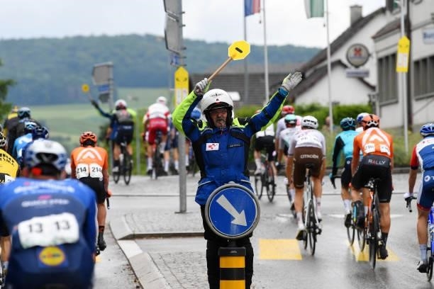 Security officer guides the peloton during the 84th Tour de Suisse 2021, Stage 2 a 178km stage from Neuhausen am Rheinfall to Lachen / Safety /...