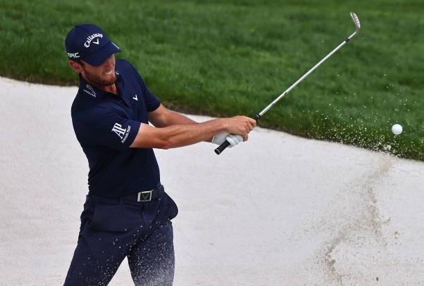 Renato Paratore of Italy plays from a greenside bunker on the 18th hole during Day Three of The Porsche European Open at Green Eagle Golf Course on...