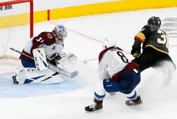 Patrick Brown of the Vegas Golden Knights shoots against Philipp Grubauer of the Colorado Avalanche for a goal as Cale Makar of the Avalanche defends...