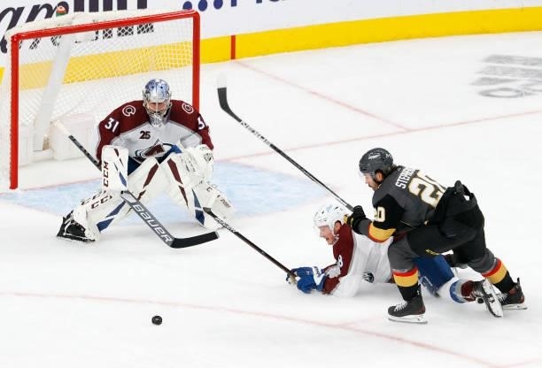 Philipp Grubauer of the Colorado Avalanche defends the net as Chandler Stephenson of the Vegas Golden Knights skates with the puck against Cale Makar...