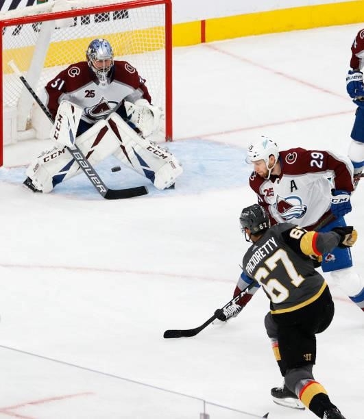 Philipp Grubauer of the Colorado Avalanche blocks a shot by Max Pacioretty of the Vegas Golden Knights as Nathan MacKinnon of the Avalanche defends...