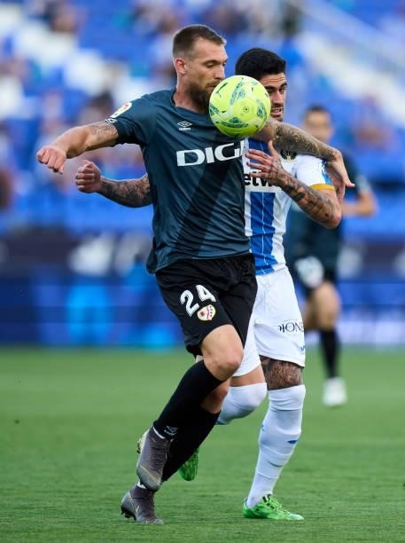 Esteban Saveljich of Rayo Vallecano competes for the ball with Miguel de la Fuente of CD Leganes during the Liga Smartbank Playoffs match between CD...