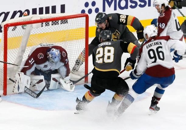 Patrick Brown of the Vegas Golden Knights scores a goal against Philipp Grubauer of the Colorado Avalanche with an assist from William Carrier of the...