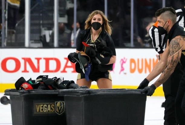 Members of the Knights Guard collect hats thrown on the ice after Jonathan Marchessault of the Vegas Golden Knights scored his third goal of the game...