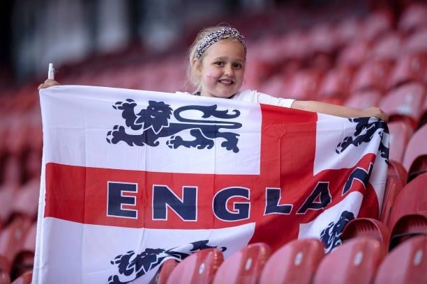 An England fan poses with a flag prior to the international friendly match between England and Romania at Riverside Stadium on June 06, 2021 in...