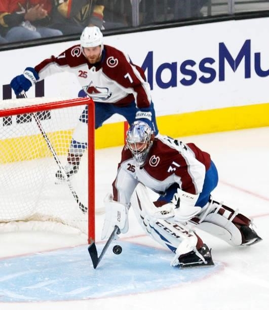 Philipp Grubauer of the Colorado Avalanche scrambles to control the puck after making a save against Chandler Stephenson of the Vegas Golden Knights...