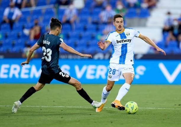 Javi Hernandez of CD Leganes is challenged by Óscar Valentin Martin of Rayo Vallecano during the Liga Smartbank Playoffs match between CD Leganes and...