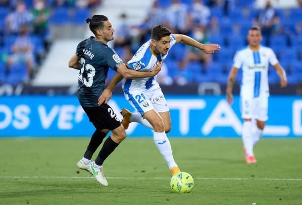 Javi Hernandez of CD Leganes is challenged by Óscar Valentin Martin of Rayo Vallecano during the Liga Smartbank Playoffs match between CD Leganes and...