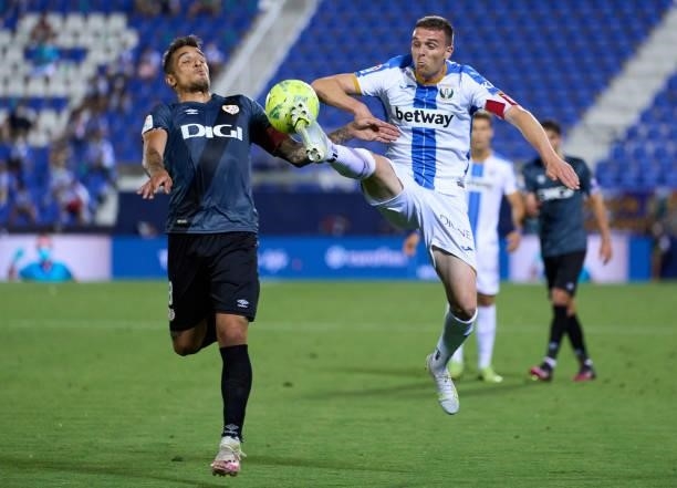 Javier Eraso of CD Leganes competes for the ball with Oscar Trejo of Rayo Vallecano during the Liga Smartbank Playoffs match between CD Leganes and...