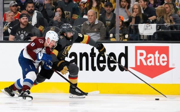 Alex Tuch of the Vegas Golden Knights skates with the puck against ahead of Cale Makar of the Colorado Avalanche in the second period in Game Four of...