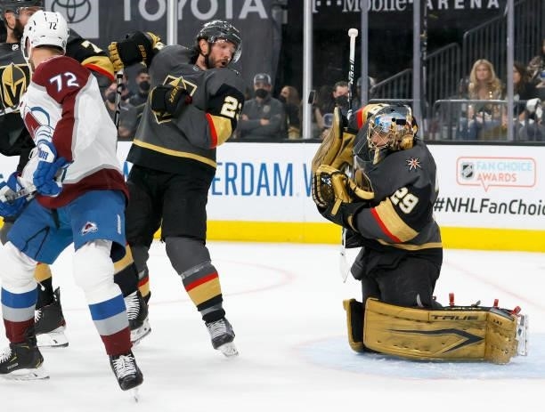 Alec Martinez of the Vegas Golden Knights keeps his eye on the puck as Marc-Andre Fleury of the Vegas Golden Knights blocks a Colorado Avalanche shot...