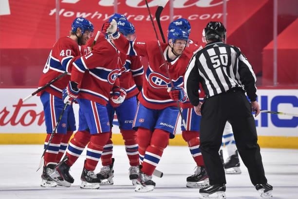 Corey Perry of the Montreal Canadiens is joined by his teammates as he celebrates his goal against the Winnipeg Jets during the first period in Game...