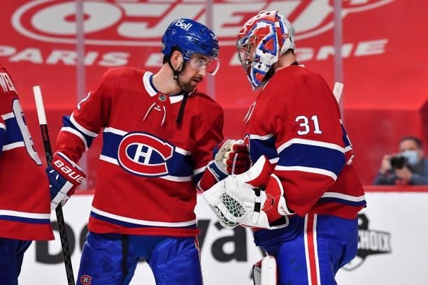Erik Gustafsson of the Montreal Canadiens congratulates goaltender Carey Price for their victory against the Winnipeg Jets in Game Three of the...