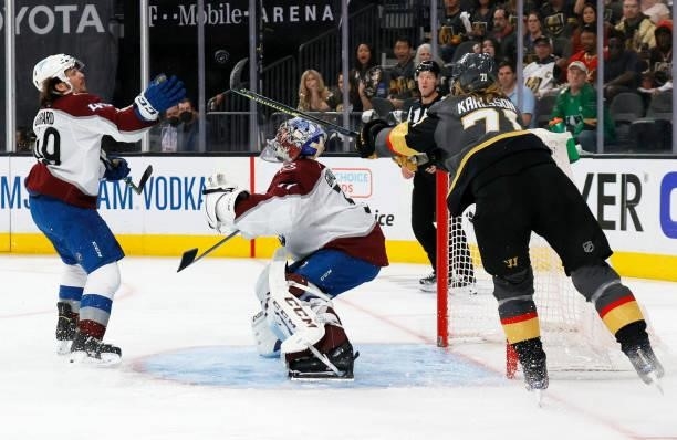 Samuel Girard of the Colorado Avalanche bats the puck away with his hand after Philipp Grubauer of the Avalanche blocked a shot by William Karlsson...