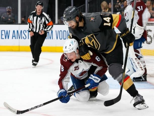 Nicolas Hague of the Vegas Golden Knights pushes Cale Makar of the Colorado Avalanche down in the second period in Game Four of the Second Round of...