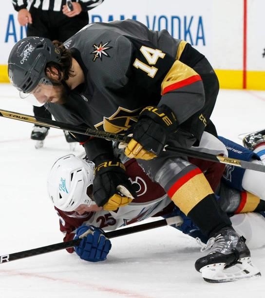 Nicolas Hague of the Vegas Golden Knights pushes Cale Makar of the Colorado Avalanche down in the second period in Game Four of the Second Round of...