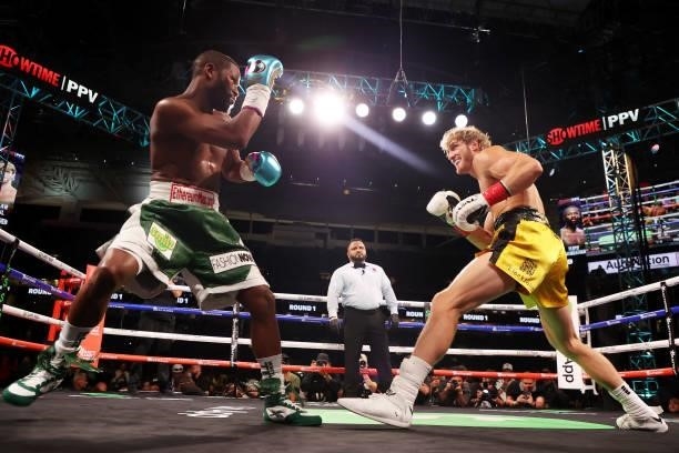 Floyd Mayweather exchanges blows with Logan Paul during their contracted exhibition boxing match at Hard Rock Stadium on June 06, 2021 in Miami...