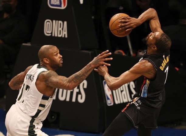 Kevin Durant of the Brooklyn Nets loses the ball as he is fouled by P.J. Tucker of the Milwaukee Bucks in the first quarter during game two of the...