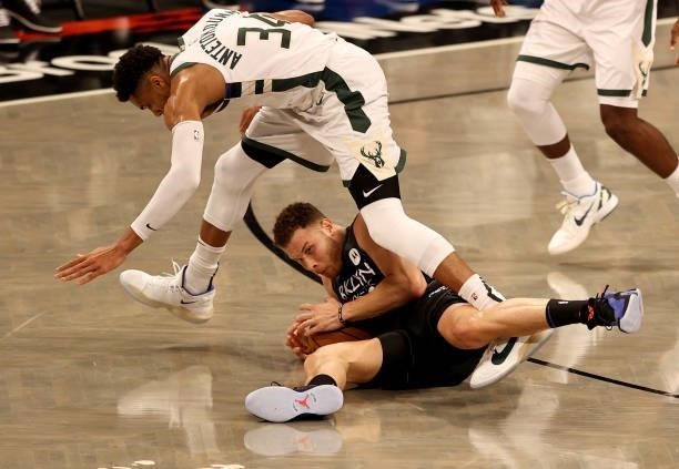 Blake Griffin of the Brooklyn Nets grabs the loose ball before Giannis Antetokounmpo of the Milwaukee Bucks in the first half during game two of the...