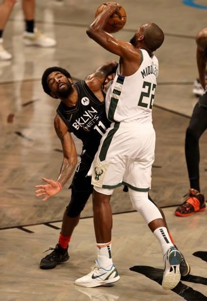 Kyrie Irving of the Brooklyn Nets and Khris Middleton of the Milwaukee Bucks collide in the first quarter during game two of the Eastern Conference...