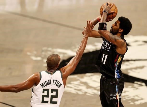 Kyrie Irving of the Brooklyn Nets takes a shot as Khris Middleton of the Milwaukee Bucks defends during game two of the Eastern Conference second...