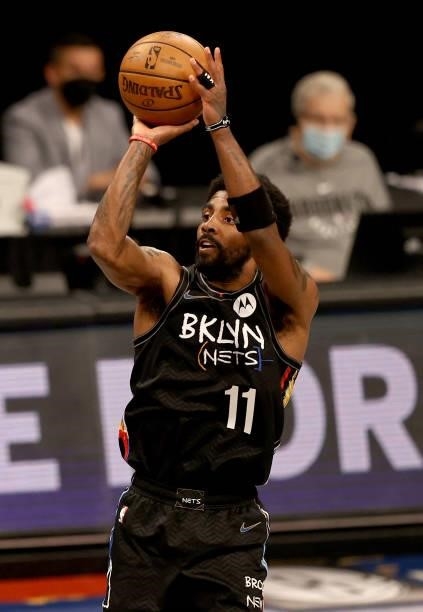 Kyrie Irving of the Brooklyn Nets shoots a three point shot in the third quarter against the Milwaukee Bucks during game two of the Eastern...