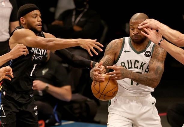 Tucker of the Milwaukee Bucks loses the ball as Bruce Brown of the Brooklyn Nets defends in the third quarter during game two of the Eastern...