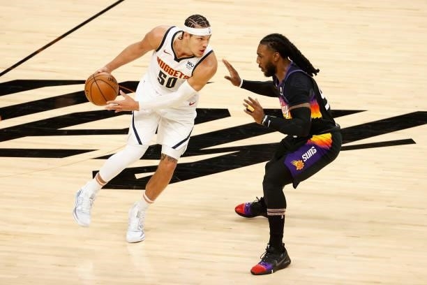Aaron Gordon of the Denver Nuggets handles the ball against Jae Crowder of the Phoenix Suns during the first half in Game One of the Western...