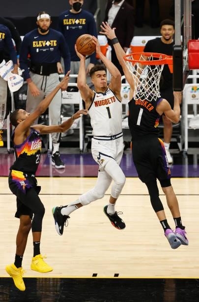 Michael Porter Jr. #1 of the Denver Nuggets attempts a shot against Devin Booker and Mikal Bridges of the Phoenix Suns during the first half in Game...