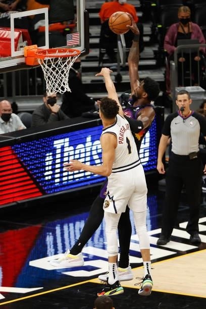 Deandre Ayton of the Phoenix Suns slam dunks the ball against Michael Porter Jr. #1 of the Denver Nuggets during the first half in Game One of the...