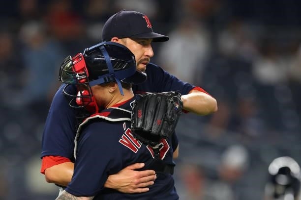 Closer Matt Barnes of the Boston Red Sox hugs catcher Christian Vazquez after defeating the New York Yankees 7-3 during a game at Yankee Stadium on...