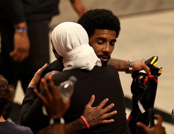 Kyrie Irving of the Brooklyn Nets hugs Manhattan district attorney candidate Tahanie Aboushi after game two of the Eastern Conference second round...