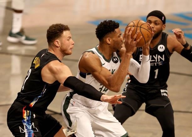 Giannis Antetokounmpo of the Milwaukee Bucks is surrounded by Blake Griffin and Bruce Brown of the Brooklyn Nets in the first quarter during game two...