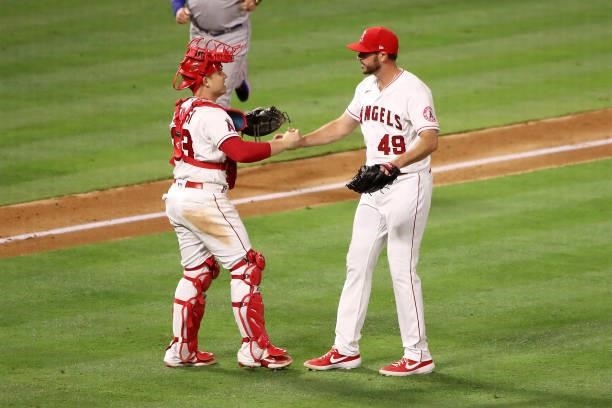Max Stassi and James Hoyt of the Los Angeles Angels celebrate their 8-3 win against the Kansas City Royals after the game at Angel Stadium of Anaheim...
