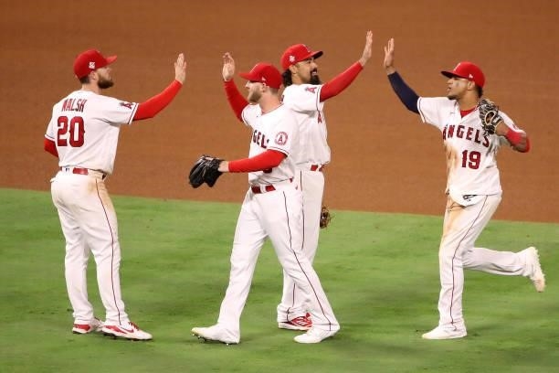 Jared Walsh, Taylor Ward, Anthony Rendon and Juan Lagares of the Los Angeles Angels celebrate their 8-3 win against the Kansas City Royals after the...