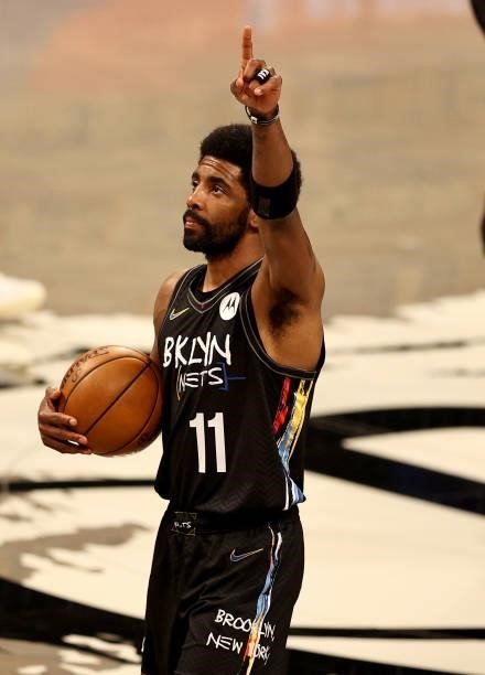 Kyrie Irving of the Brooklyn Nets salutes the fans before game two of the Eastern Conference second round series against the Milwaukee Bucks at...