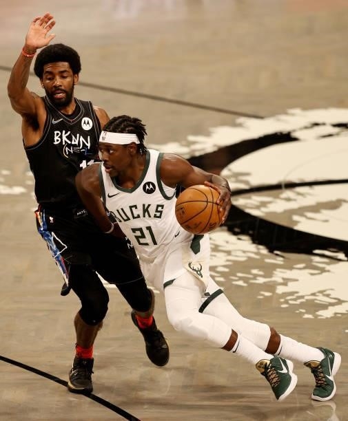 Jrue Holiday of the Milwaukee Bucks drives around Kyrie Irving of the Brooklyn Nets in the first quarter during game two of the Eastern Conference...