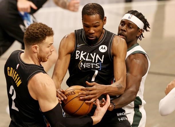 Blake Griffin and Kevin Durant of the Brooklyn Nets grab the rebound before Jrue Holiday of the Milwaukee Bucks in the first quarter during game two...
