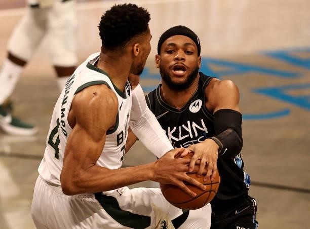 Giannis Antetokounmpo of the Milwaukee Bucks and Bruce Brown of the Brooklyn Nets fight for the ball in the first quarter during game two of the...