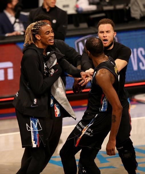 Kevin Durant of the Brooklyn Nets celebrates with teammates Nicolas Claxton and Blake Griffin of the Brooklyn Nets during a time out in the first...