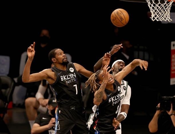 Kevin Durant and Nicolas Claxton of the Brooklyn Nets fight for the rebound with Bobby Portis of the Milwaukee Bucks iduring game two of the Eastern...