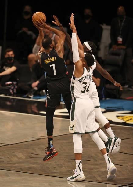 Kevin Durant of the Brooklyn Nets takes a shot as Giannis Antetokounmpo and Jrue Holiday of the Milwaukee Bucks defend in the first half during game...