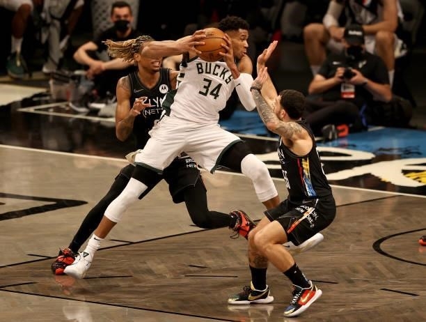 Giannis Antetokounmpo of the Milwaukee Bucks heads for the net as Nicolas Claxton and Mike James of the Brooklyn Nets defend in the second half...