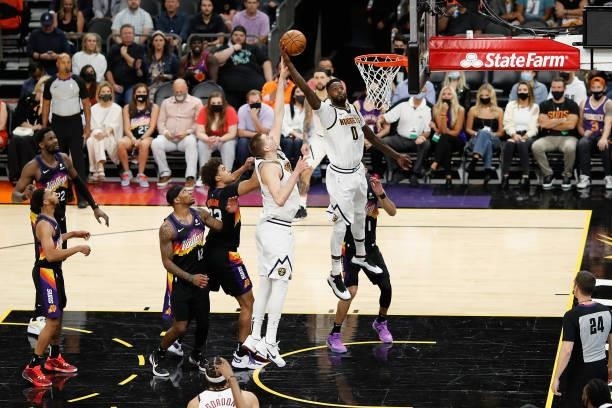 JaMychal Green of the Denver Nuggets slam dunks the ball against the Phoenix Suns during the second half in Game One of the Western Conference...