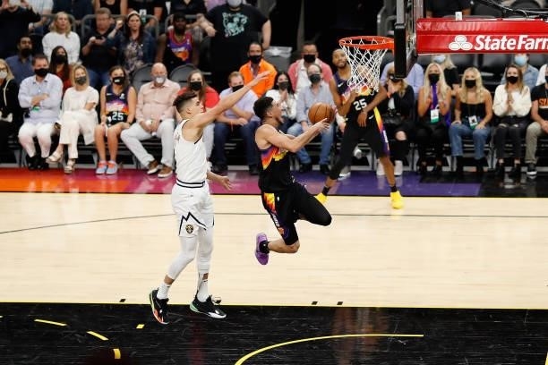 Devin Booker of the Phoenix Suns attempts a lay-up shot past Michael Porter Jr. #1 of the Denver Nuggets during the second half in Game One of the...