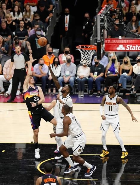 Dario Saric of the Phoenix Suns attempts a shot over JaMychal Green of the Denver Nuggets during the first half in Game One of the Western Conference...