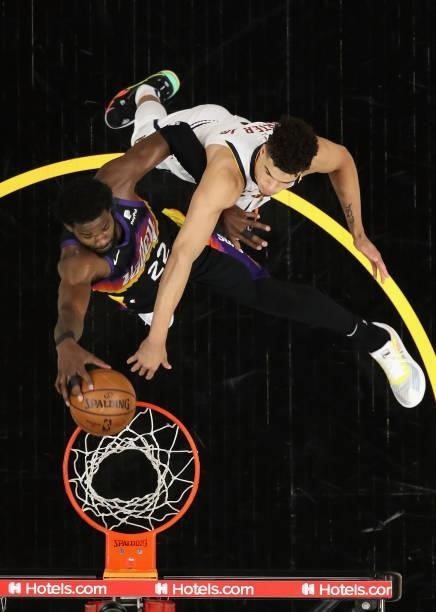 Deandre Ayton of the Phoenix Suns slam dunks the ball against Michael Porter Jr. #1 of the Denver Nuggets during the second half in Game One of the...