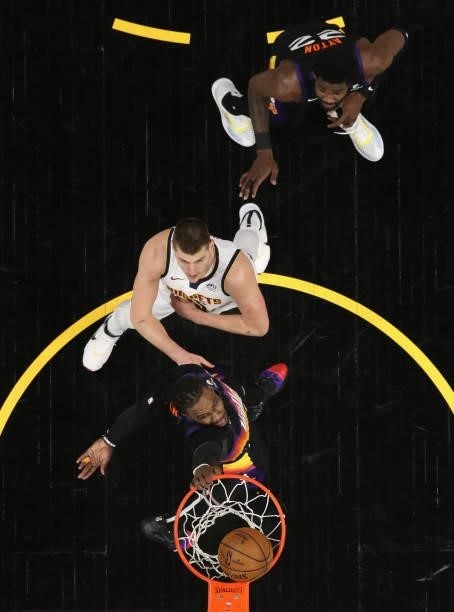 Jae Crowder of the Phoenix Suns puts up a shot ahead of Nikola Jokic of the Denver Nuggets during the first half in Game One of the Western...