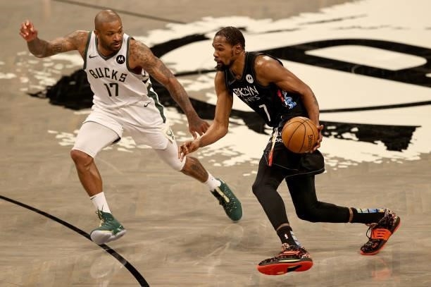 Kevin Durant of the Brooklyn Nets drives past P.J. Tucker of the Milwaukee Bucks defends during game two of the Eastern Conference second round...